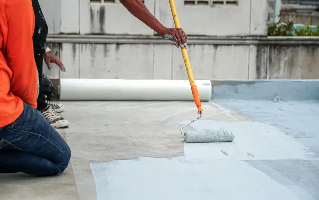 Waterproofing roller on a roof for foundation repair services